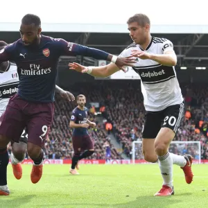 Arsenal's Alexandre Lacazette Clashes with Fulham's Maxime Le Marchand in Premier League Showdown