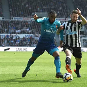 Arsenal's Alexandre Lacazette Clashes with Newcastle's Paul Dummett in Premier League Showdown