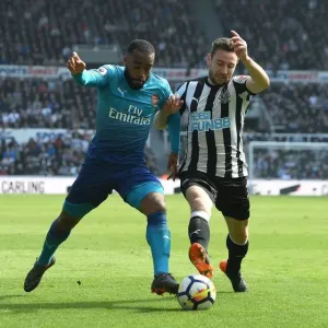 Arsenal's Alexandre Lacazette Clashes with Newcastle's Paul Dummett in Premier League Showdown