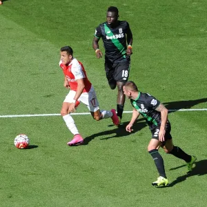 Arsenal's Alexis Sanchez Chases Down Stoke Duo Mame Biram Diouf and Phil Bardsley Arsenal's Alexis Sanchez Chases Down Stoke Duo Mame Biram Diouf and Phil Bardsley