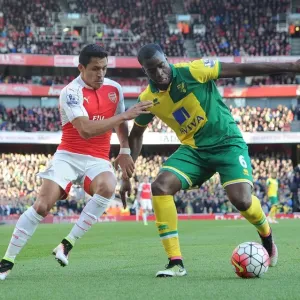 Arsenal's Alexis Sanchez Closes In on Norwich's Sebastien Bassong during the 2015-16 Premier League Match Arsenal's Alexis Sanchez Closes In on Norwich's Sebastien Bassong during the 2015-16 Premier League Match