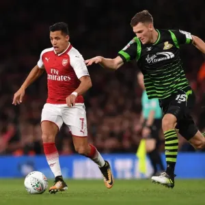 Arsenal's Alexis Sanchez Faces Off Against Joe Wright in Carabao Cup Battle