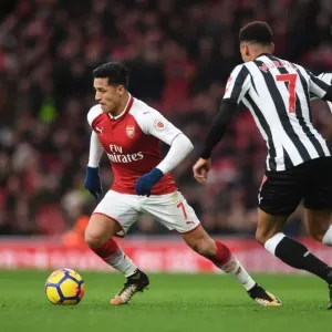 Arsenal's Alexis Sanchez Faces Off Against Newcastle's Mikel Merino and Jacob Murphy in Intense Premier League Clash