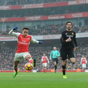 Arsenal's Alexis Sanchez Fends Off Hull's Andrea Ranocchia During Premier League Clash