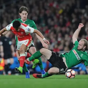 Arsenal's Alexis Sanchez Outmaneuvers Lincoln City Defenders during The Emirates FA Cup Quarter-Final Arsenal's Alexis Sanchez Outmaneuvers Lincoln City Defenders during The Emirates FA Cup Quarter-Final