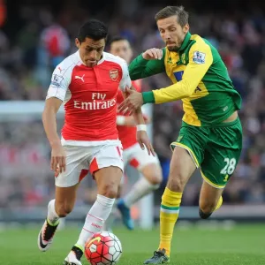 Arsenal's Alexis Sanchez vs. Norwich's Gary O'Neil: Intense Face-off during the 2015-16 Premier League Match Arsenal's Alexis Sanchez vs. Norwich's Gary O'Neil: Intense Face-off during the 2015-16 Premier League Match