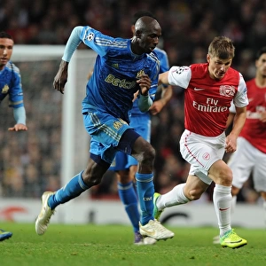 Arsenal's Andrey Arshavin Breaks Past Marseille's Alou Diarra in 2011-12 Champions League Clash