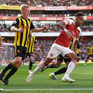 Arsenal's Aubameyang Clashes with Watford's Hughes in Premier League Showdown