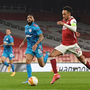 Arsenal's Aubameyang in Europa League Action: Emirates Stadium Showdown vs. Olympiacos Amidst Empty Seats (2020-21)