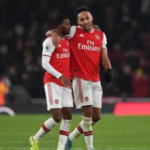 Arsenal's Aubameyang and Maitland-Niles Celebrate Victory Over Manchester United (2019-20) Arsenal's Aubameyang and Maitland-Niles Celebrate Victory Over Manchester United (2019-20)