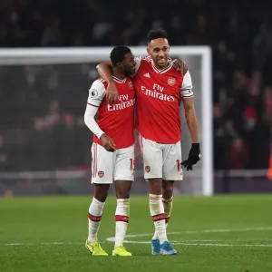Arsenal's Aubameyang and Maitland-Niles Celebrate Victory Over Manchester United (2019-20) Arsenal's Aubameyang and Maitland-Niles Celebrate Victory Over Manchester United (2019-20)