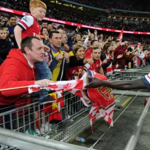 Arsenal's Bacary Sagna Embraces Fan with Team Flag after FA Cup Semi-Final Victory Arsenal's Bacary Sagna Embraces Fan with Team Flag after FA Cup Semi-Final Victory