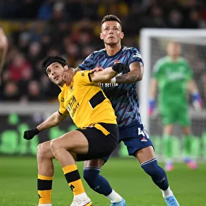 Arsenal's Ben White Fends Off Raul Jimenez in Intense Wolverhampton Wanderers Clash (Premier League 2021-22)