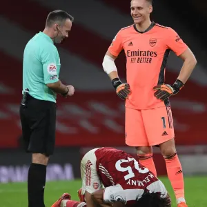 Arsenal's Bernd Leno Shares a Laugh with Referee Paul Tierney Amidst Mohamed Elneny Injury at Emirates Stadium