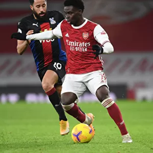 Arsenal's Bukayo Saka in Action: Premier League Showdown at Empty Emirates Against Crystal Palace, 2021