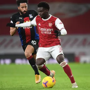 Arsenal's Bukayo Saka in Action: Premier League Showdown at Empty Emirates Against Crystal Palace, 2021