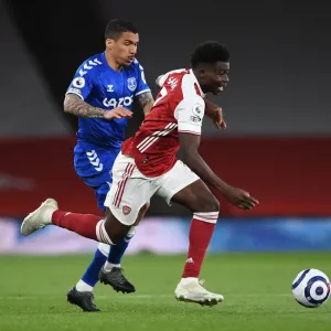 Arsenal's Bukayo Saka Clashes with Everton's Allan in Premier League Showdown