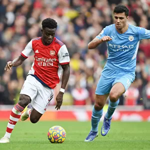 Arsenal's Bukayo Saka Clashes with Manchester City's Rodri in Premier League Showdown