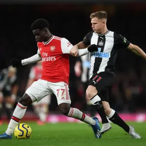 Arsenal's Bukayo Saka Clashes with Newcastle's Matt Ritchie in Premier League Showdown Arsenal's Bukayo Saka Clashes with Newcastle's Matt Ritchie in Premier League Showdown
