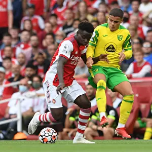 Arsenal's Bukayo Saka Clashes with Norwich's Max Aarons in Premier League Showdown