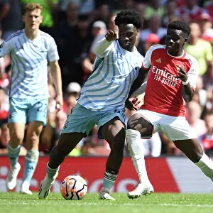 Arsenal's Bukayo Saka Clashes with Nottingham Forest's Ola Aina in 2023-24 Premier League Showdown