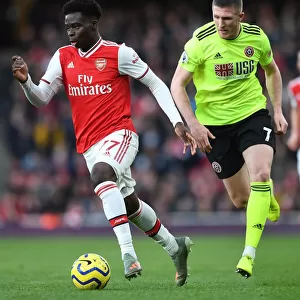 Arsenal's Bukayo Saka Clashes with Sheffield United's John Lundstram in Premier League Showdown