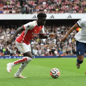 Arsenal's Bukayo Saka Clashes with Tottenham's Destiny Udogie in the 2023-24 Premier League Showdown at Emirates Stadium Arsenal's Bukayo Saka Clashes with Tottenham's Destiny Udogie in the 2023-24 Premier League Showdown at Emirates Stadium