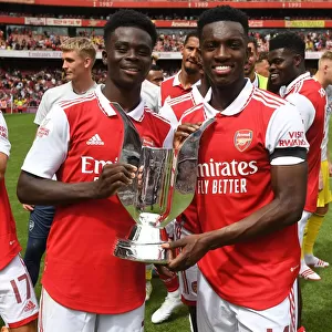 Arsenal's Bukayo Saka and Eddie Nketiah Lift Emirates Cup after Arsenal v Sevilla Pre-Season Friendly