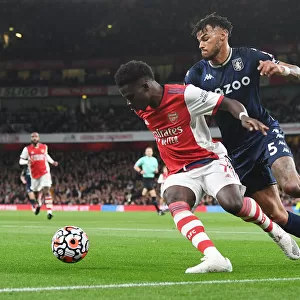 Arsenal's Bukayo Saka Faces Off Against Aston Villa's Tyrone Mings in Premier League Showdown