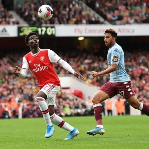 Arsenal's Bukayo Saka Faces Off Against Aston Villa's Trezeguet in Intense Premier League Clash