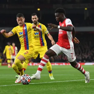 Arsenal's Bukayo Saka Faces Off Against Crystal Palace's Joel Ward in Premier League Clash