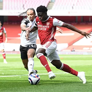 Arsenal's Bukayo Saka Faces Off Against Fulham's Bobby De Cordova-Reid in Empty Emirates Stadium, Premier League 2020-21