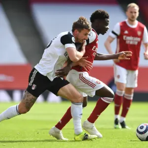Arsenal's Bukayo Saka Faces Off Against Fulham's Joe Bryan in Empty Emirates Stadium, Premier League 2020-21