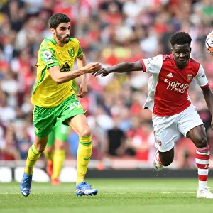 Arsenal's Bukayo Saka Faces Off Against Norwich's Pierre Lees-Melou in Premier League Clash