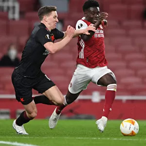 Arsenal's Bukayo Saka Faces Off Against Slavia Praha's Lukas Provod in UEFA Europa League Quarterfinal at Empty Emirates Stadium