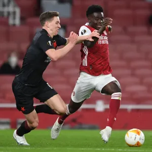 Arsenal's Bukayo Saka Faces Off Against Slavia Praha's Lukas Provod in UEFA Europa League Quarterfinal at Empty Emirates Stadium