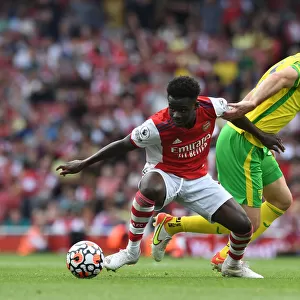 Arsenal's Bukayo Saka Fends Off Norwich's Grant Hanley During Premier League Clash