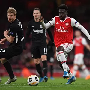 Arsenal's Bukayo Saka Goes Head-to-Head with Eintracht Frankfurt's Martin Hinteregger in Europa League Showdown