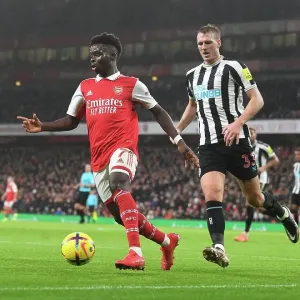 Arsenal's Bukayo Saka Goes Head-to-Head with Newcastle's Dan Burn in Premier League Battle