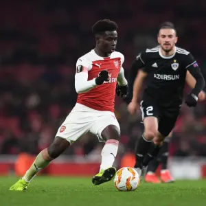 Arsenal's Bukayo Saka Goes Head-to-Head with Qarabag's Gara Gareyev in Europa League Battle