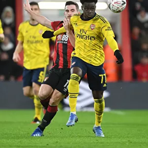 Arsenal's Bukayo Saka Outmaneuvers Lewis Cook in FA Cup Clash