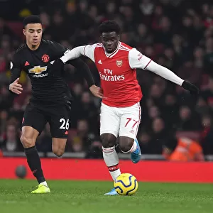 Arsenal's Bukayo Saka Outmaneuvers Manchester United's Mason Greenwood in Premier League Clash