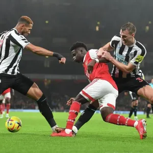 Arsenal's Bukayo Saka Overpowers Newcastle's Defense: Intense Battle against Joelinton and Dan Burn, 2023