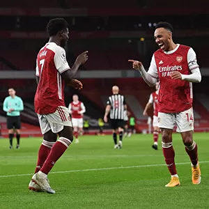 Arsenal's Bukayo Saka and Pierre-Emerick Aubameyang Celebrate Goals Amidst Empty Emirates Stadium (Arsenal v Newcastle United, Premier League 2021)