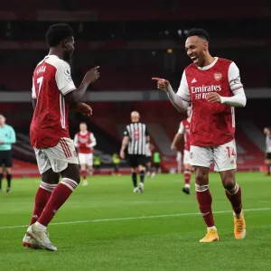 Arsenal's Bukayo Saka and Pierre-Emerick Aubameyang Celebrate Goals Amidst Empty Emirates Stadium (Arsenal v Newcastle United, Premier League 2021)