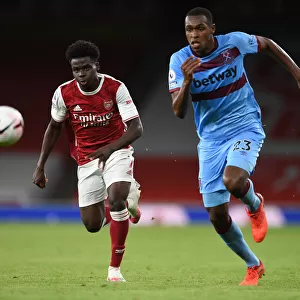 Arsenal's Bukayo Saka Takes on West Ham's Issa Diop in Premier League Clash
