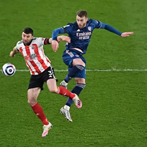Arsenal's Calum Chambers Fights for Control Against Sheffield United in Premier League Clash