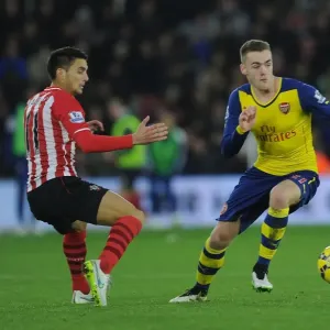 Arsenal's Calum Chambers Outmaneuvers Southampton's Dusan Tadic in Premier League Clash