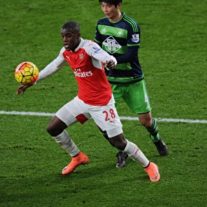 Arsenal's Campbell Fends Off Swansea's Sung-Yueng in Premier League Battle (2015-16)