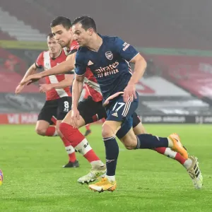Arsenal's Cedric Outmaneuvers Southampton's Bednarek in Empty St. Mary's Stadium - Premier League 2021 (Southampton vs Arsenal)